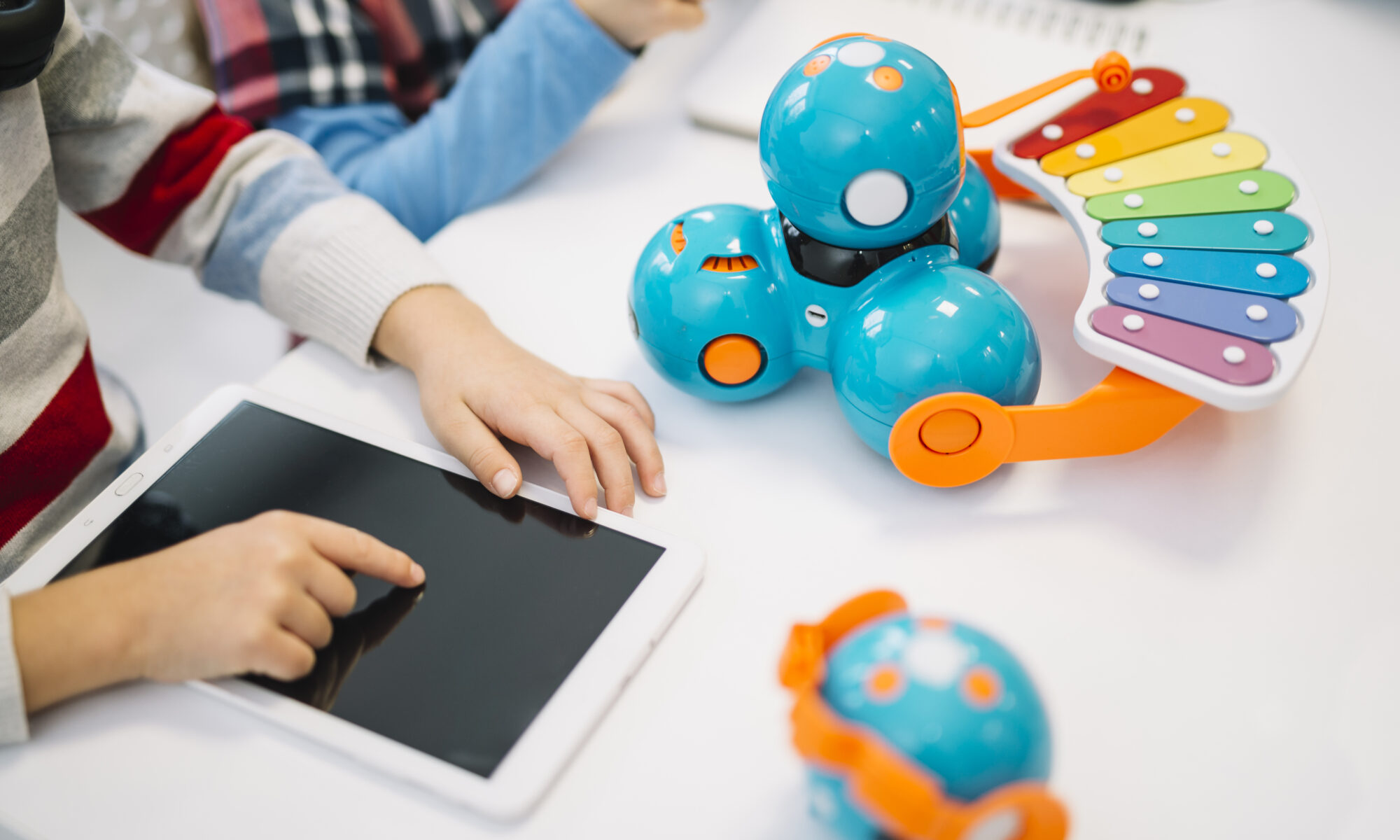 Close Up Boy Touching Digital Tablet Screen White Desk | Play and Dream Toys UAE