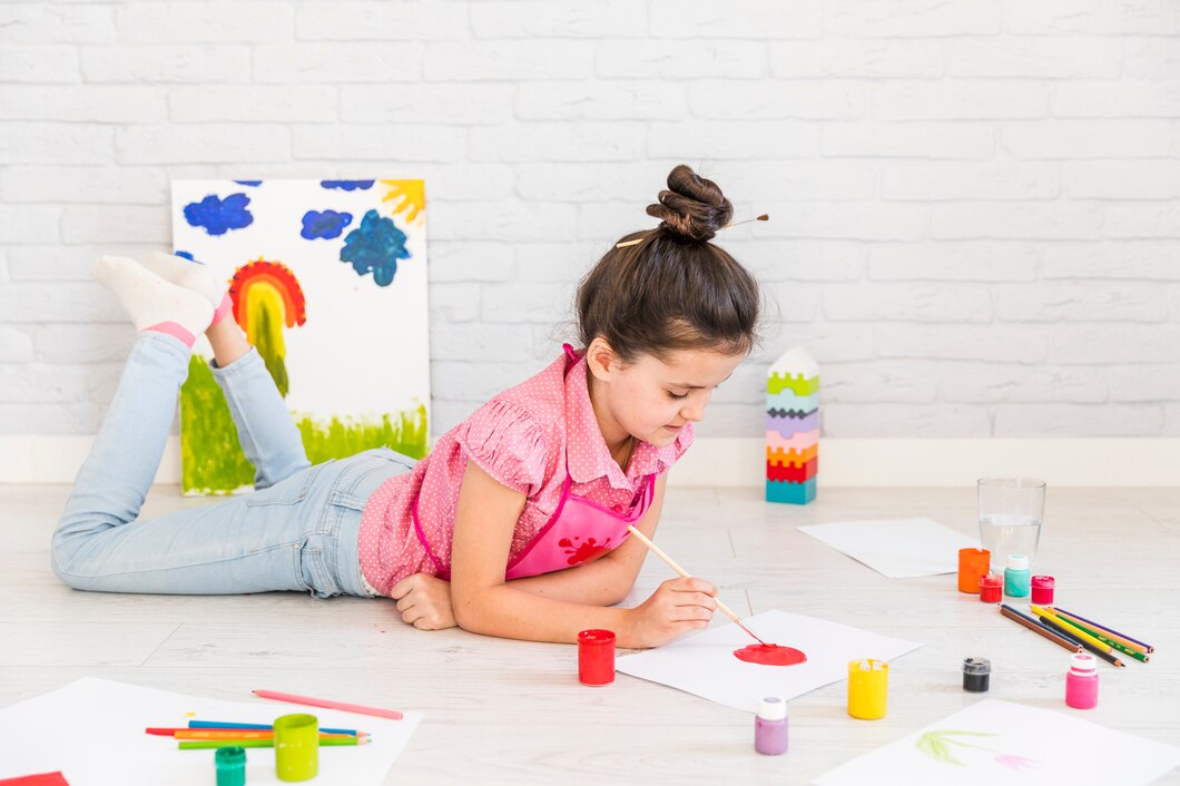 Girl Lying Floor Painting White Paper With Brush | Play and Dream Toys UAE