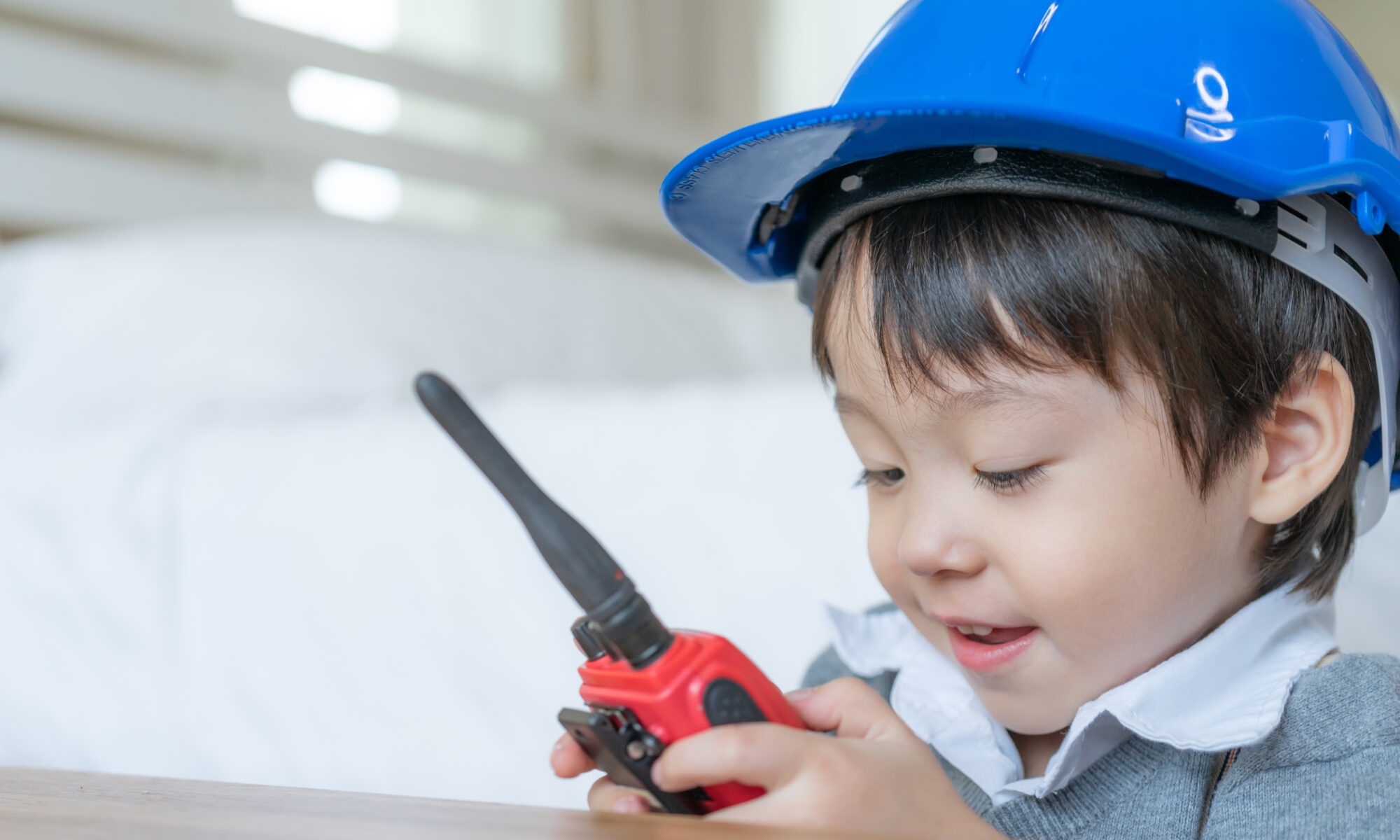 Little Cute Boy Wearing Blue Helmet Enjoying Talking With Red Walkie Talkie Redio Bedroom | Play and Dream Toys UAE